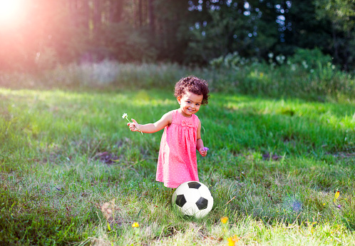 Toddler and the soccer ball outside