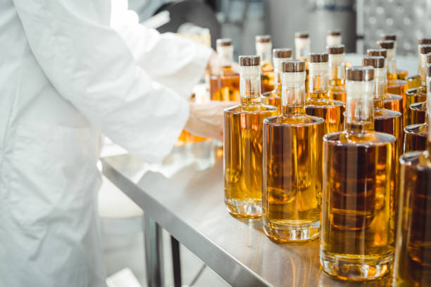 istock Person in lab coat analyzing bottles of pure alcohol. 1144440519