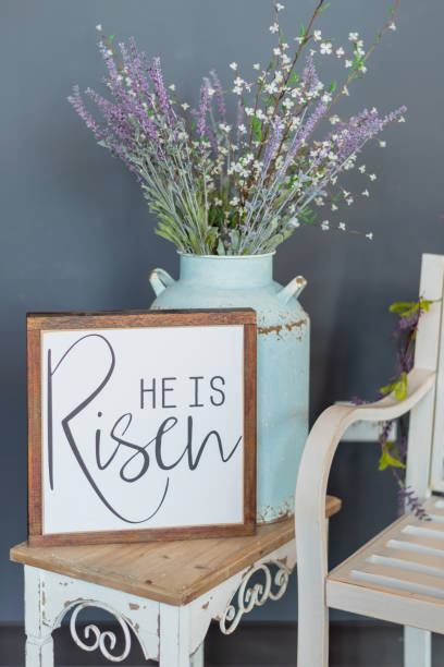 istock Easter background with sign that says “He is Risen” - vertical 1144440562