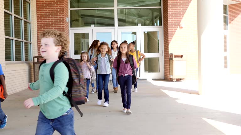 Diverse group of students leave school at the end of the day