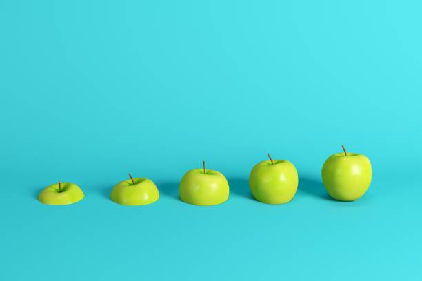 istock Slices of fresh green apple on blue background. Minimal fruit idea concept. 1144441666