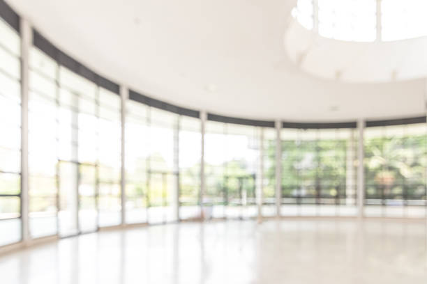 istock Blur background interior view looking out toward to empty office lobby and entrance doors and glass curtain wall 1144443502