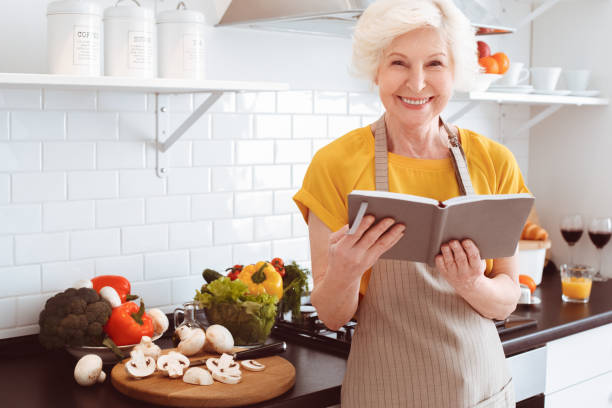 istock Grandmother keeps a diary, plans what to cook 1144444242