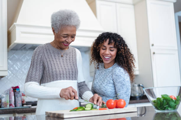 istock Mother and daughter cooking together 1144444287
