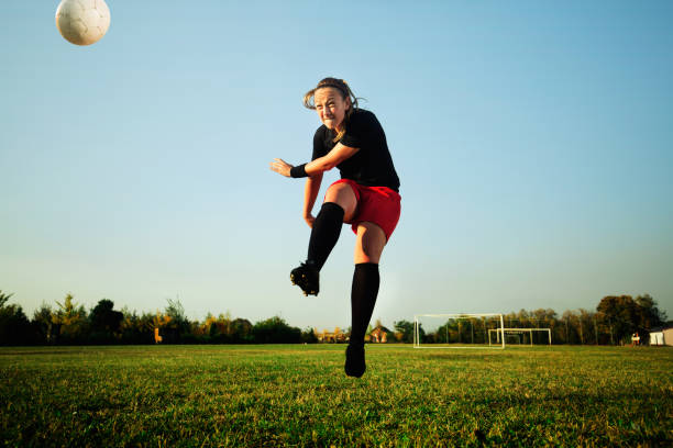 istock Female soccer player shoot the ball 1144446593