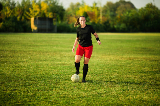 istock Female soccer player shoot the ball 1144446595