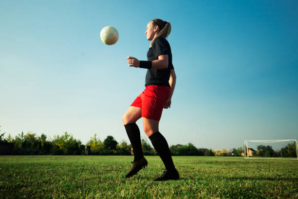 istock Female soccer player shoot the ball 1144447237