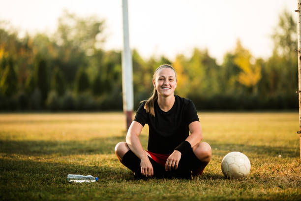 istock Female soccer player resting 1144447451