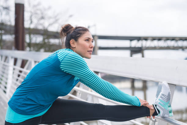 istock An woman stretches before going for a run in the city 1144447684