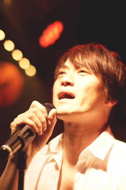 istock Young man sings with a microphone 1144447709