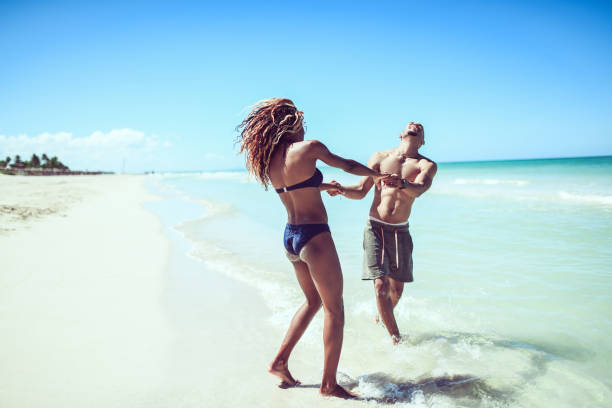 Couple Swinging And Having Fun At The Beach