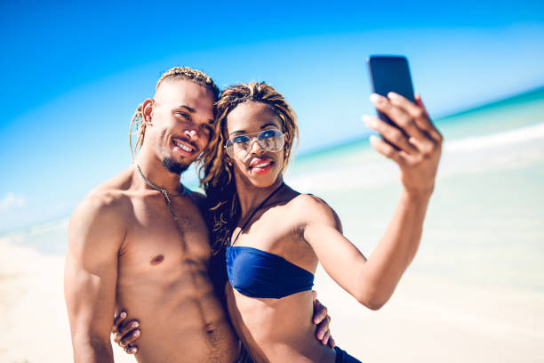 istock Afro-American Couple Taking Selfie At The Beach 1144448425