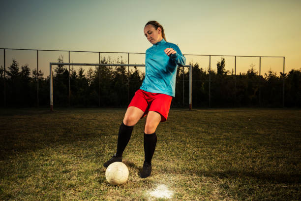 istock Young woman playing soccer 1144448535