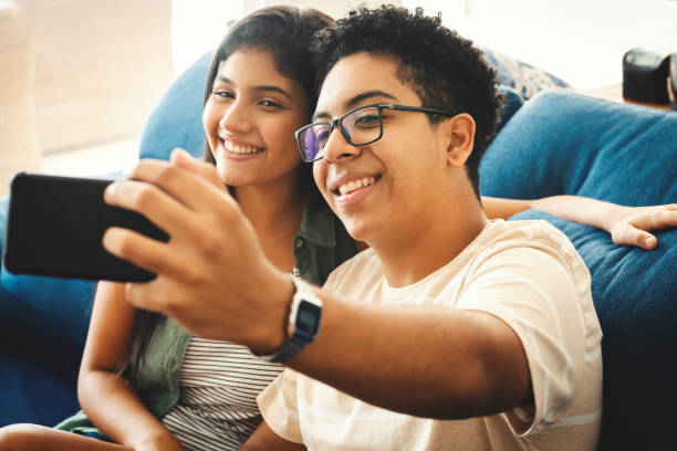 istock Two teenagers taking selfie on the couch and smiling 1144448539