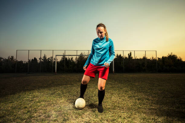 istock Young woman playing soccer 1144449647