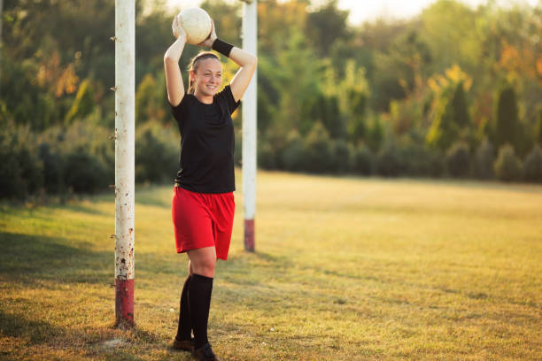 istock Beautiful young female soccer player throws the ball 1144449885