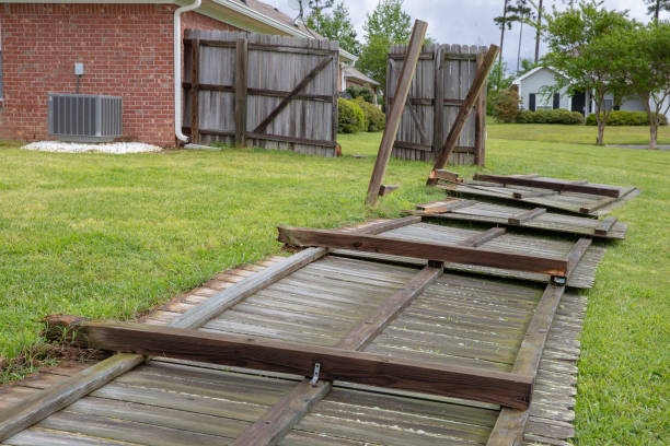Wood fence blown over during severe storm and tornado stock photo