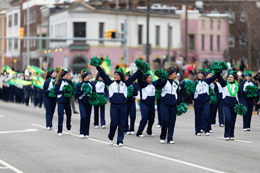 Indianapolis, Indiana, USA - March 15, 2019: St. Patrick's Day Parade, Members of the Irish Cheerleaders Cathedral High School performing at the parade
