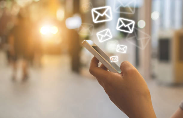istock Close-up image hand using smartphone with icon envelope email. Contact us customer service or e-mail marketing concept 1144453398