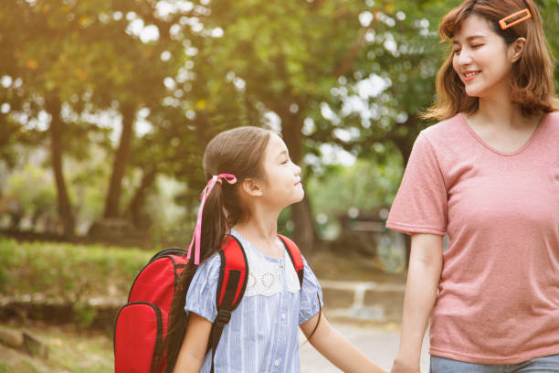 istock Mother and child holding hands going to school 1144458121