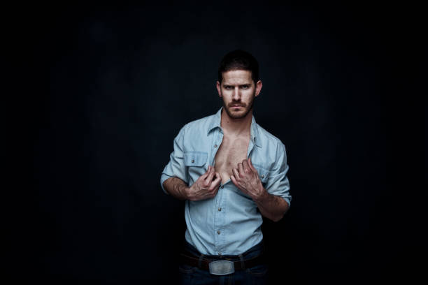 istock Sexy cowboy undressing 1144459925