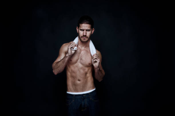 istock Handsome shirtless man holding a towel 1144460597