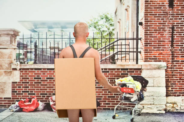 istock Poverty man in box shirtless looking away 1144461477