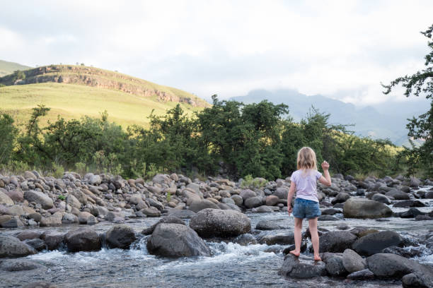 istock Little girl playing in the river 1144465044