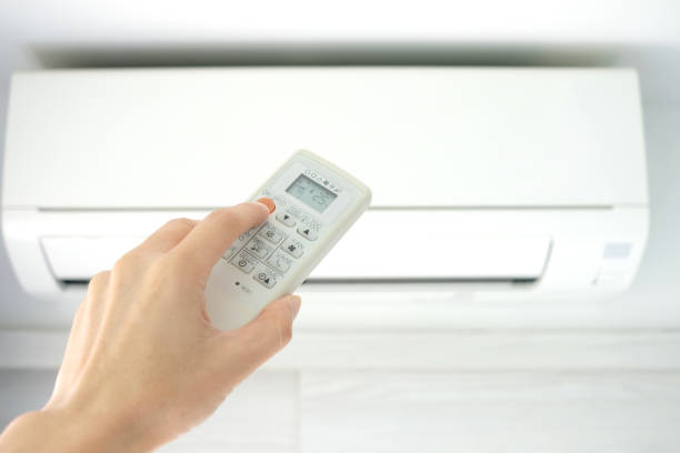 istock Man's hand using remote control open The air conditioner is cooled to 25 degrees Celsius in his bedroom. Health concepts and energy savings 1144468587