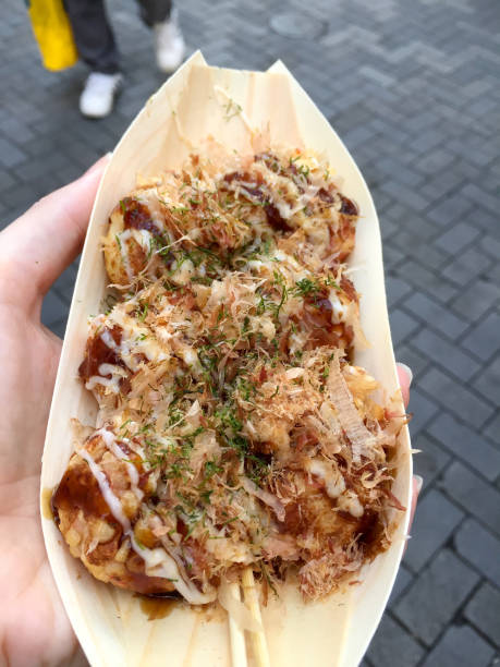 istock Female hand holding Takoyaki plate 1144468678