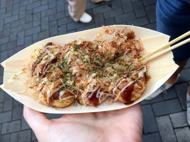 istock Female hand holding Takoyaki plate 1144468689