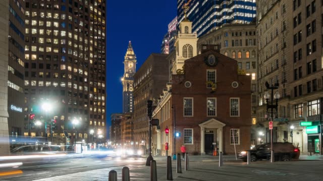 4K Time lapse of crowned people and traffic in front area of Boston old state house at the twilight time, Massachusetts, USA downtown skyline, Architecture and building with tourist concept.