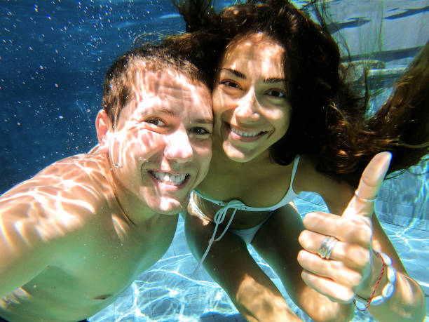 istock Happy smiling couple underwater. 1144472628