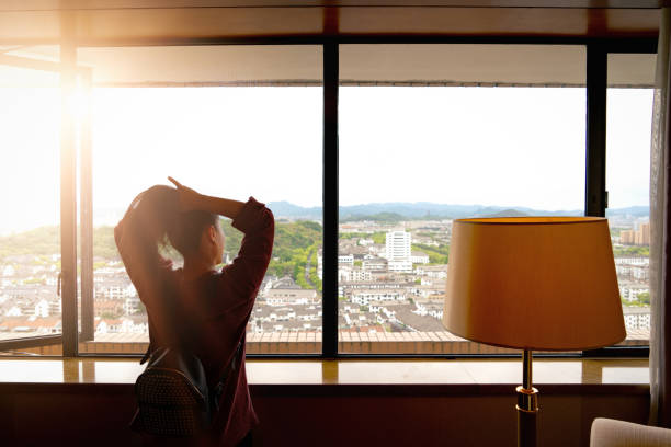 istock Woman tight hair ready while looking at view from window 1144472639
