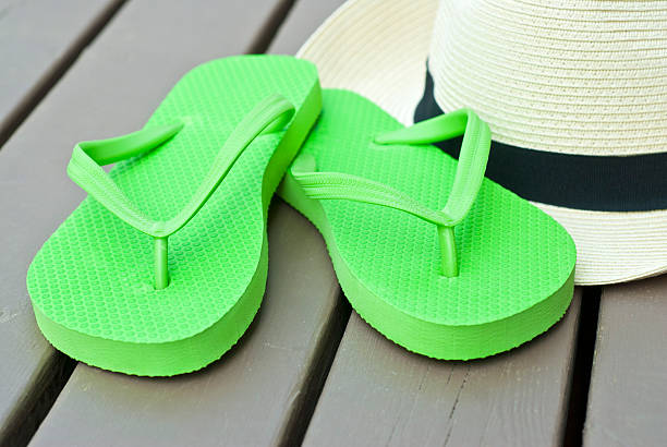 istock Lime Green Flip Flops and Straw Hat 114447651