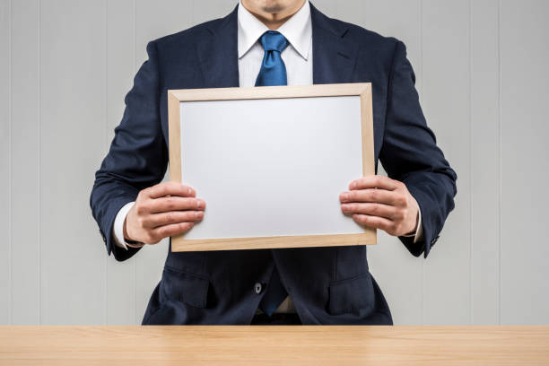 istock Businessman holding a board in his hand 1144477548