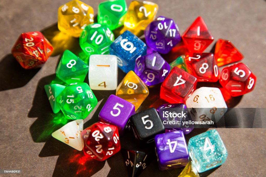 D20 says A set of dice including D20 on dark background. Dice often used in role playing games such as Dungeons and Dragons Dice Stock Photo