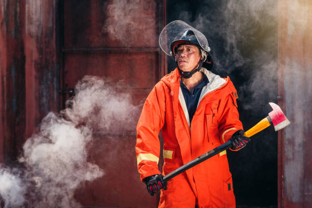 istock Firefighters fighting a fire operation, fireman holding ax, Firefighters extinguish burning warehouse 1144480996