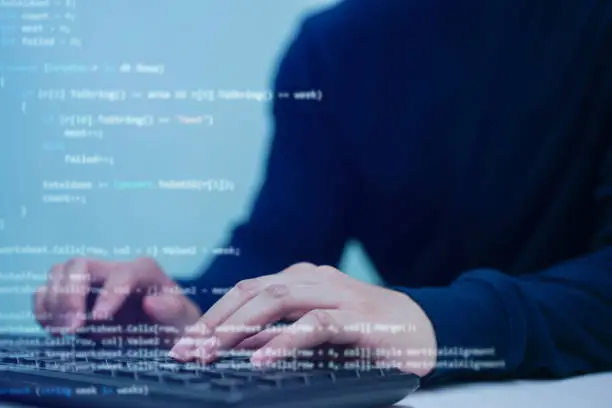 Photo of close up programmer man hand typing on keyboard at computer desktop for input coding language to software for fix bug and defect of system in operation room , technology concept