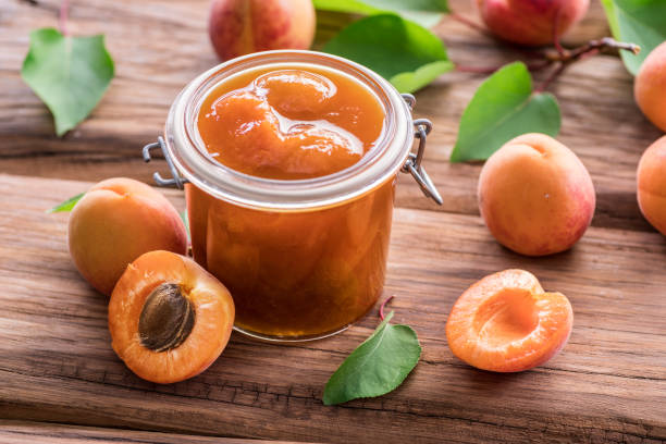 istock Apricot jam and ripe apricots on the table. 1144486165