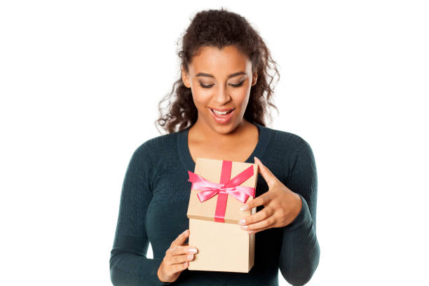 istock happy african woman opens a box with a gift 1144488624