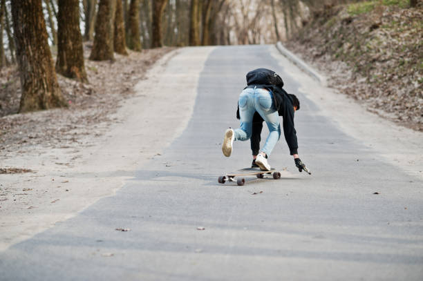 istock Street style arab man in eyeglasses with longboard 1144489838