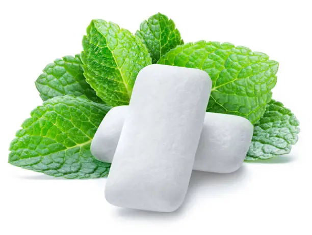 Chewing gum pads with mint leaves on white background.