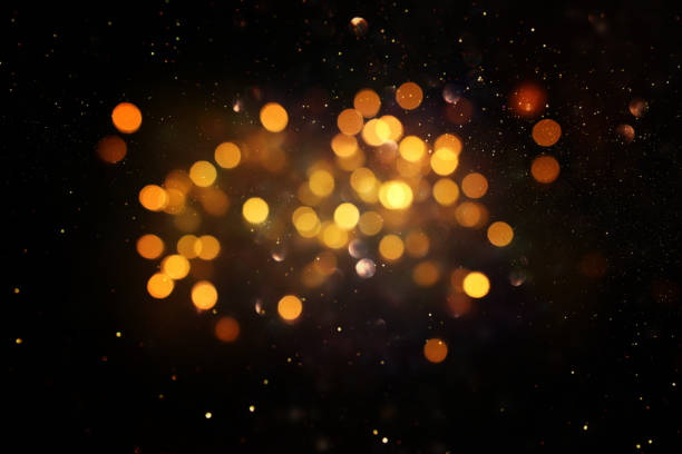 istock glitter vintage lights background. black and gold. de-focused 1144490290