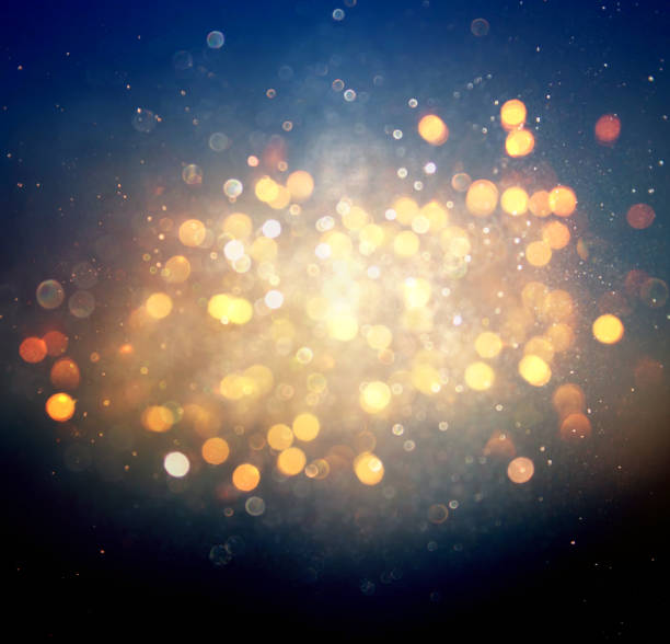 istock glitter vintage lights background. black, blue and gold. de-focused 1144490304