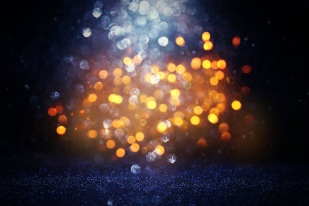 istock glitter vintage lights background. black, blue and gold. de-focused 1144490306