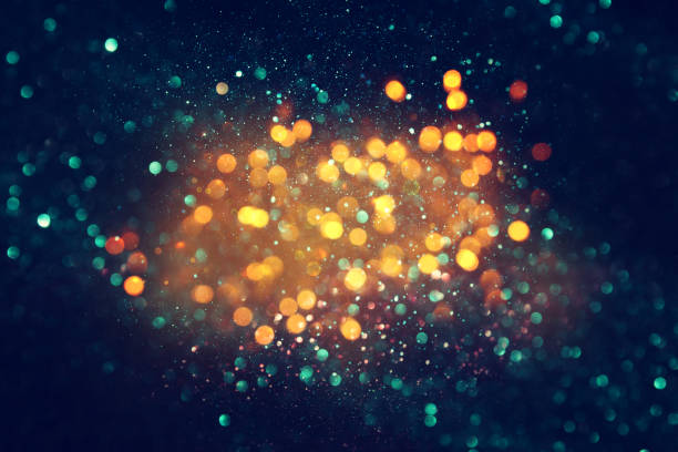 istock glitter vintage lights background. black, blue and gold. de-focused 1144490312
