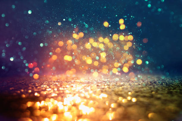istock glitter vintage lights background. black, blue and gold. de-focused 1144490316