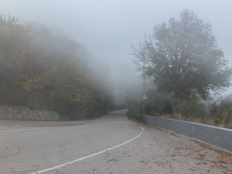 Thick fog covers old road Pass Baidar Gates in Crimean Mountains connecting Baydar Valley with Black Sea coast
