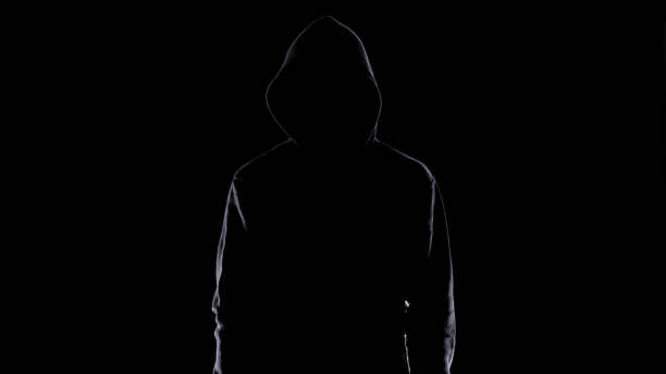 Dangerous anonymous male in night darkness, scary terrorist preparing for crime